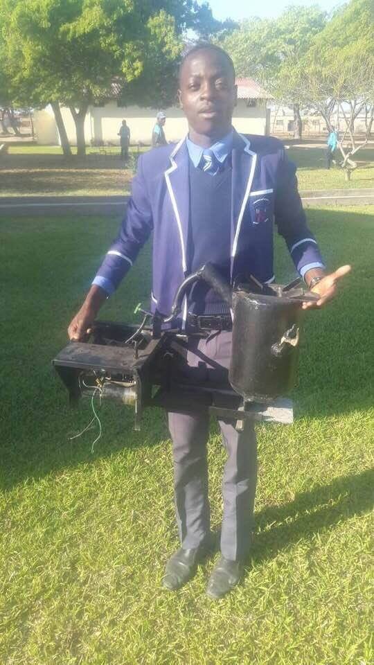 A student holding a charcoal stove