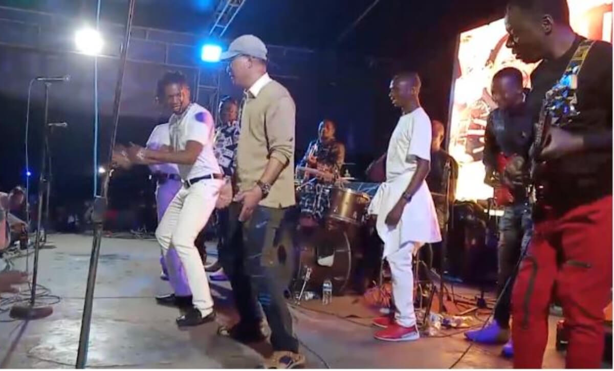 Chinese man dancing with Alick Macheso's band on stage